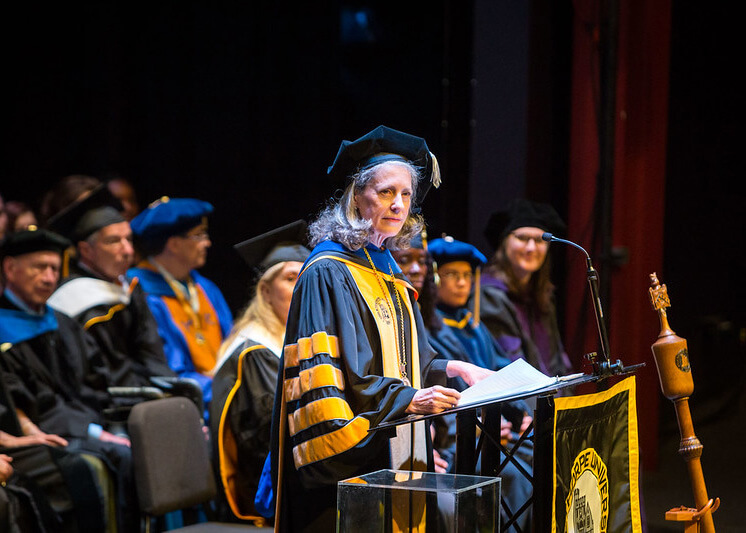 Dr. McClymond stands at the podium during her inauguration.